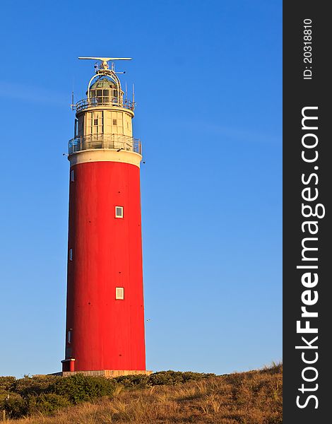 Seaside with sand dunes and lighthouse on a sunny day. Seaside with sand dunes and lighthouse on a sunny day