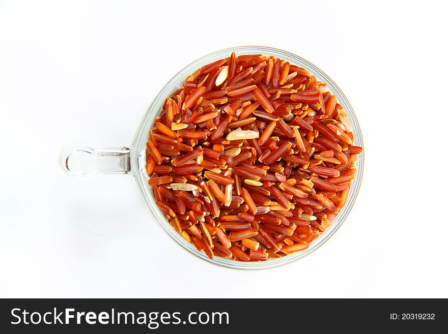 Red jasmine rice and beaker on a white background