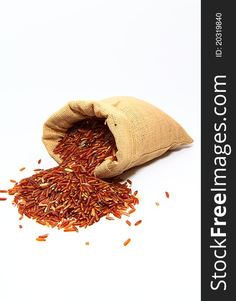 Red jasmine rice and beaker on a white background
