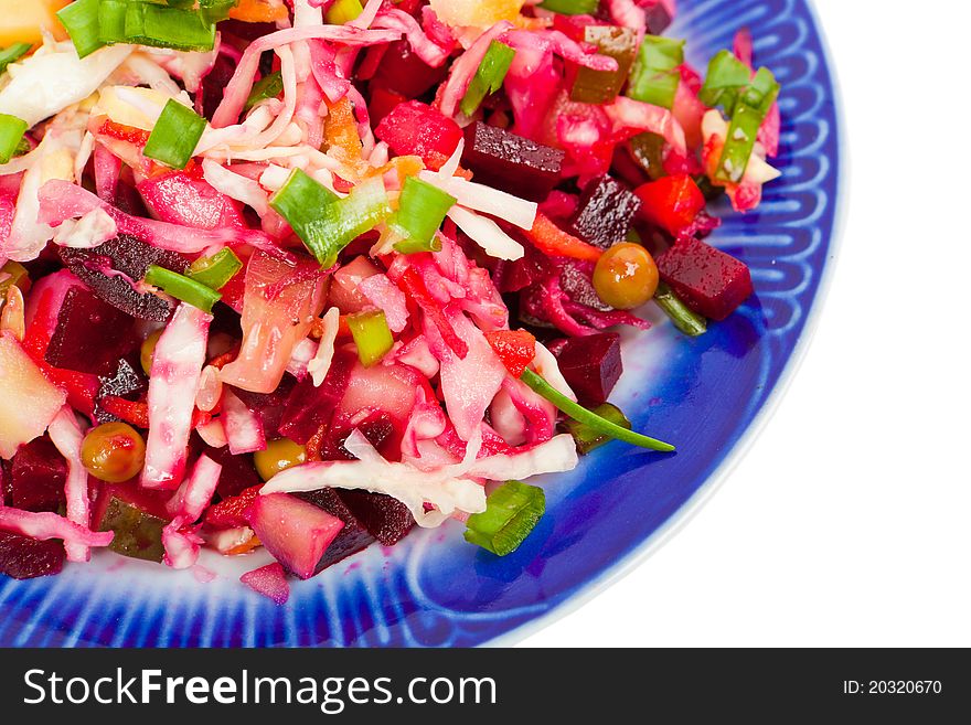 Vegetable salad on a plate with a dark blue border