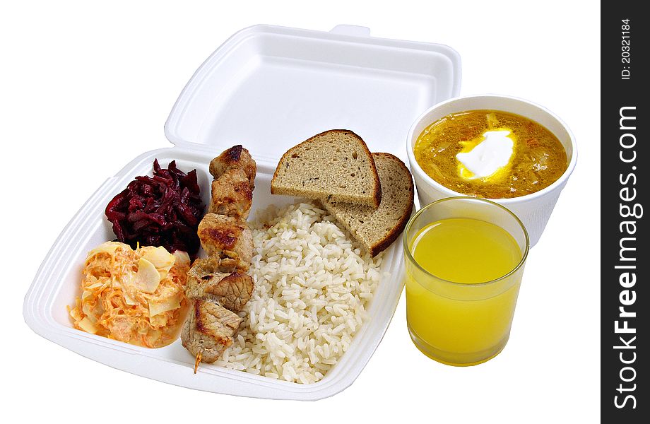 Dinner set to take away. Rice, shashlik, salads, cabbage soup and juice. Isolated on white background.