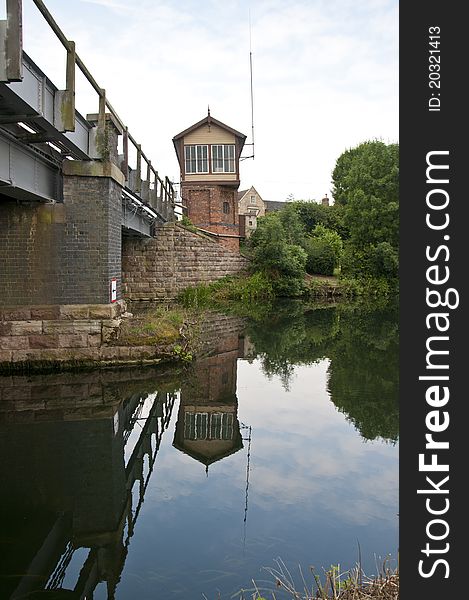 Old working signal box from across the river with bridge. Old working signal box from across the river with bridge