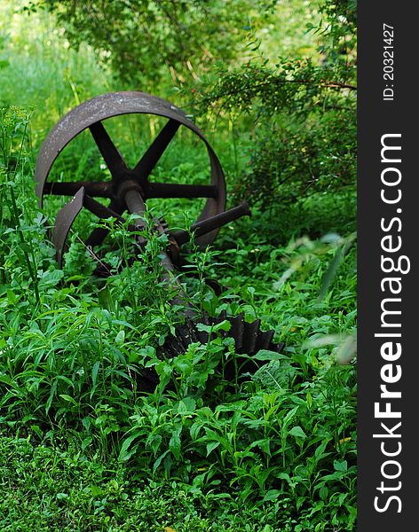 Long forgotten piece of equipment. Laying among the green grass of summer, The new growth and old together make for a great picture