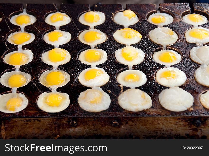 Fried eggs on a round iron plate. Fried eggs on a round iron plate