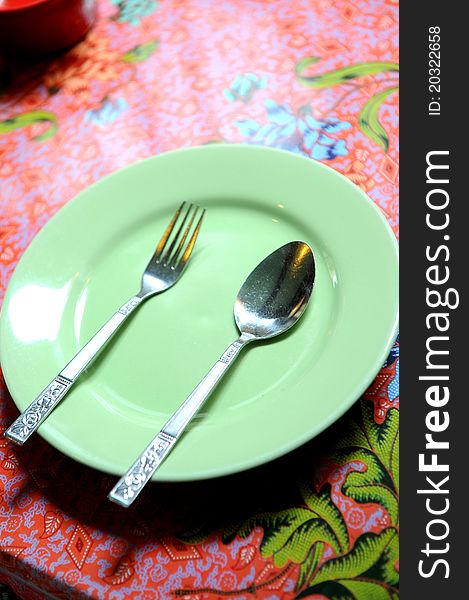 Green plate on red background