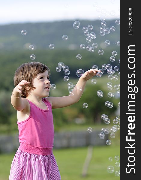 Little girl playing with balloons in nature in summer season. Little girl playing with balloons in nature in summer season