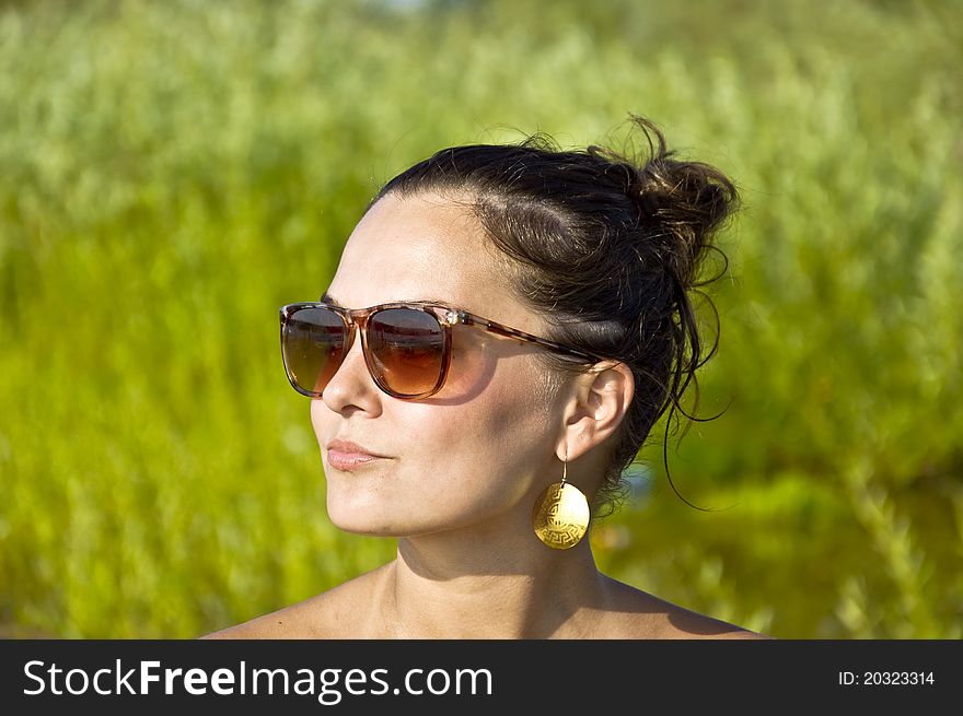 Girl in sunglasses on the beach