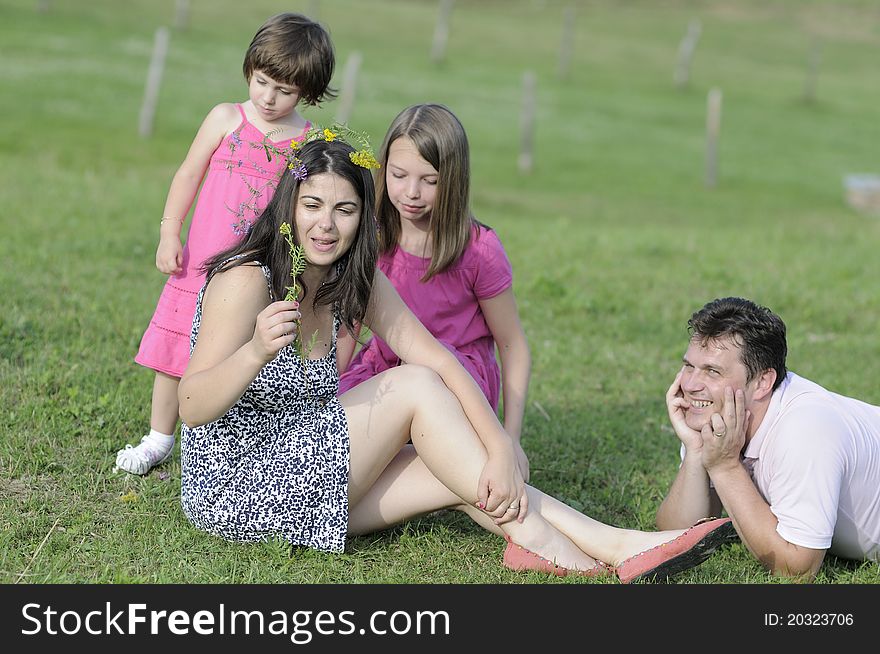 Beautiful family working with flowers and creating wreath in summer season. Beautiful family working with flowers and creating wreath in summer season