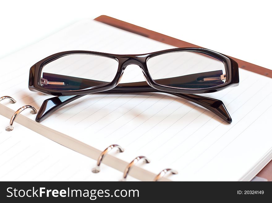 Eyeglasses with Notebook on a white background. Eyeglasses with Notebook on a white background