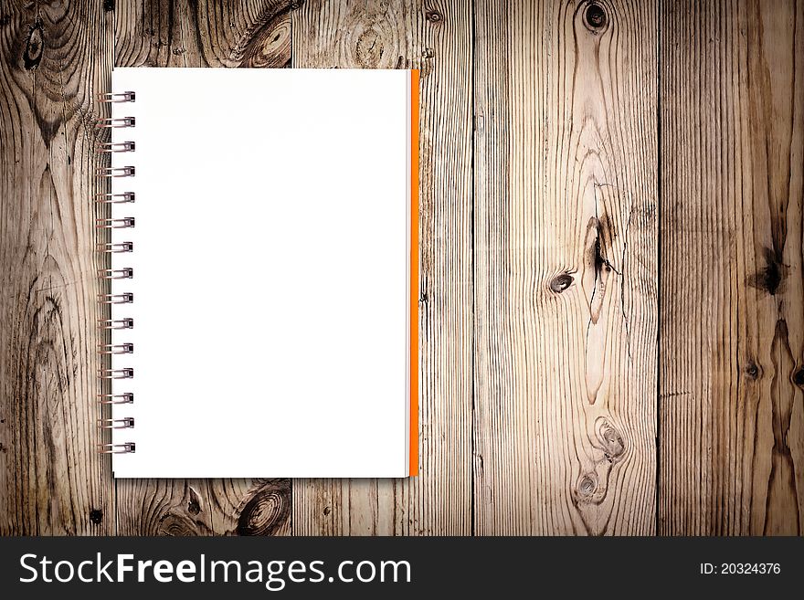 White notebook on wooden background