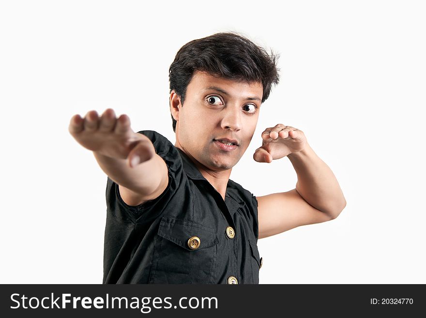 Angry Indian man in attacking position in extreme rage over white background