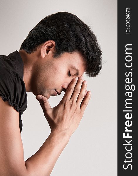 Indian man in the position of thinking his head supported by hand and closed eyes. Indian man in the position of thinking his head supported by hand and closed eyes