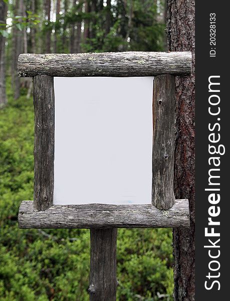 A blank wooden framed sign in forest to use for your own message. A blank wooden framed sign in forest to use for your own message.