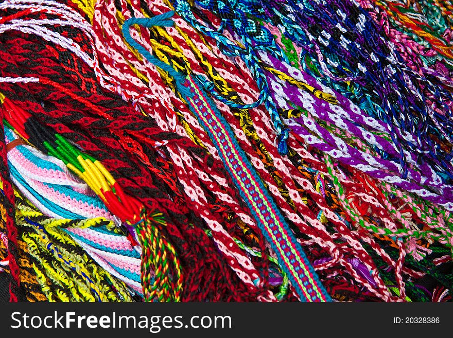 A pile of colorful ribbons with different woven patterns