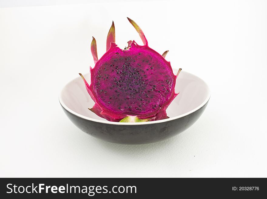 Red organic dragon fruit cutting in cup on white background. Red organic dragon fruit cutting in cup on white background