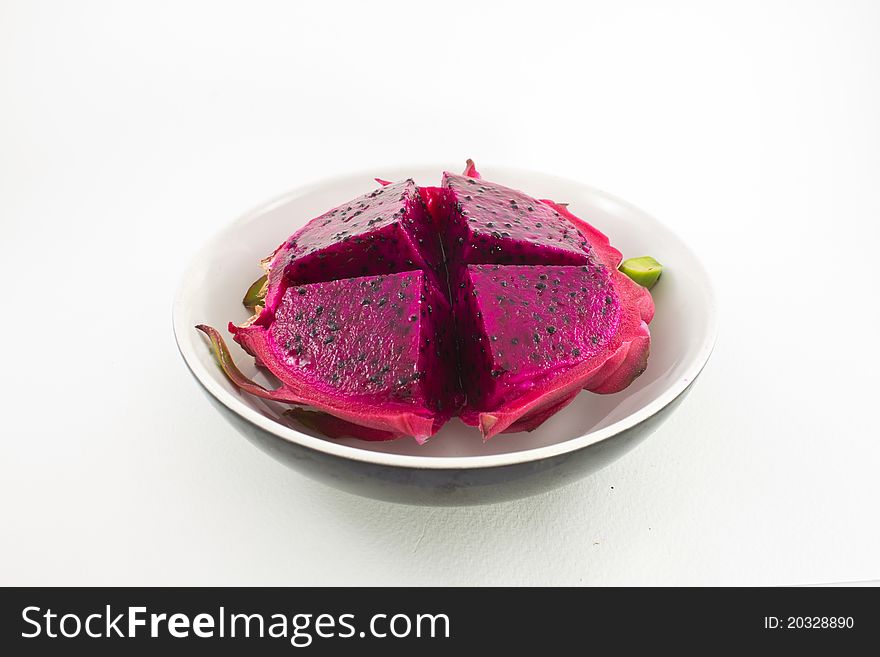 Red organic dragon fruit cutting in cup on white background. Red organic dragon fruit cutting in cup on white background