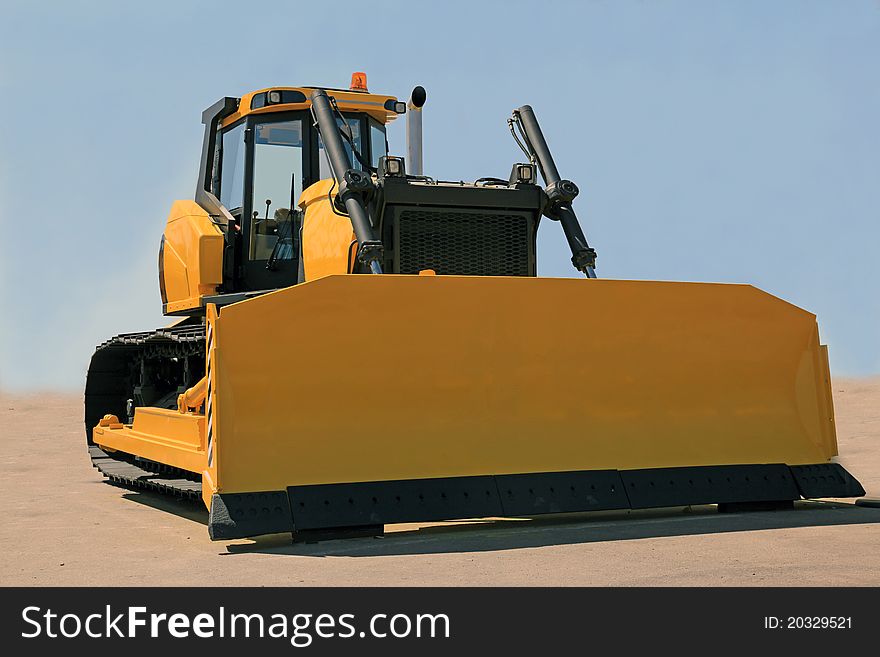 A large yellow bulldozer at a construction site