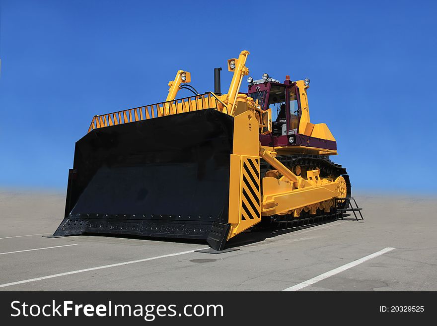 A large yellow bulldozer at a construction site