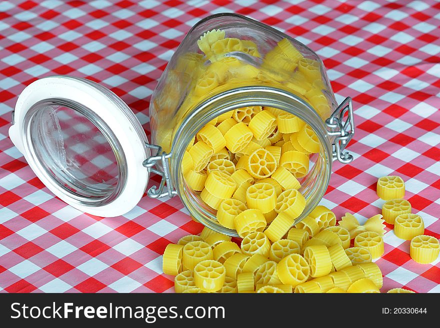 An image of bright yellow pasta in a jar