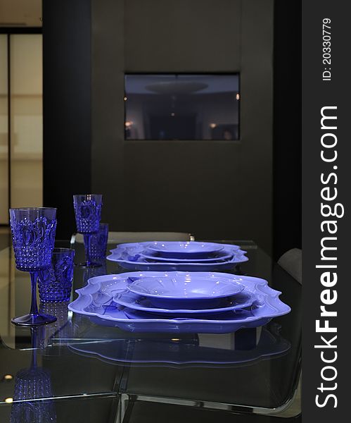 Table setting with violet glasswine and plates. Table setting with violet glasswine and plates.