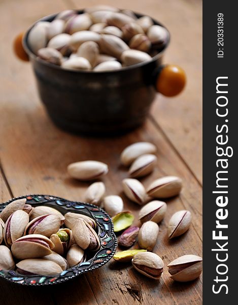 Pistachios on natural wooden table background