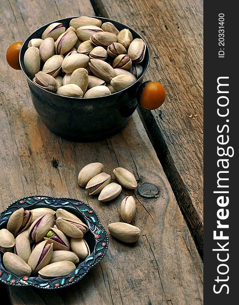 Pistachios on natural wooden table background