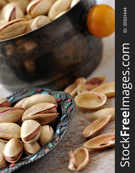 Pistachios on natural wooden table background