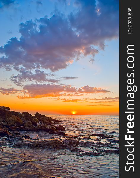 Beautiful sunset against the sea and rocks. Beautiful sunset against the sea and rocks