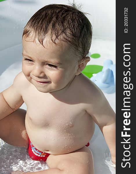 Child has fun in the pool with toy