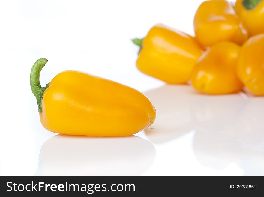 A yellow baby pepper against a white background