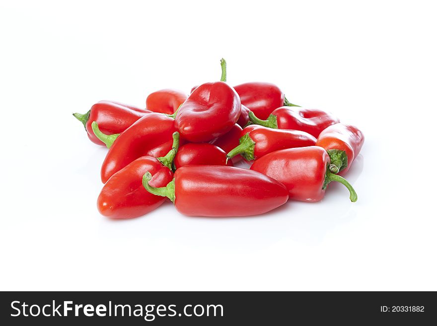 A red baby pepper against a white background