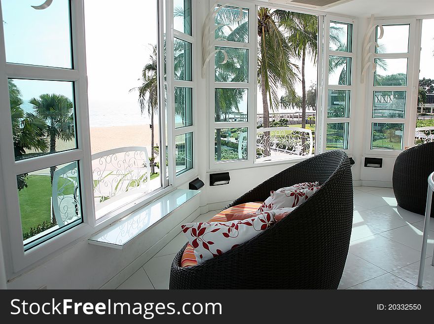 Rattan Chairs With Colorful Cushions.