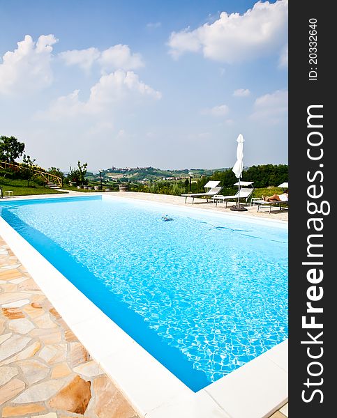 Swimming pool of an Italian beauty farm in the middle vineyards, Monferrato area, Piemonte region. Swimming pool of an Italian beauty farm in the middle vineyards, Monferrato area, Piemonte region.