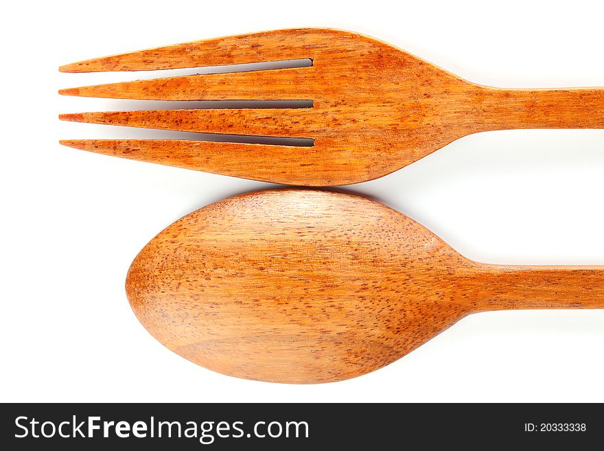 Spoon and fork produces from the wood on white background. Spoon and fork produces from the wood on white background