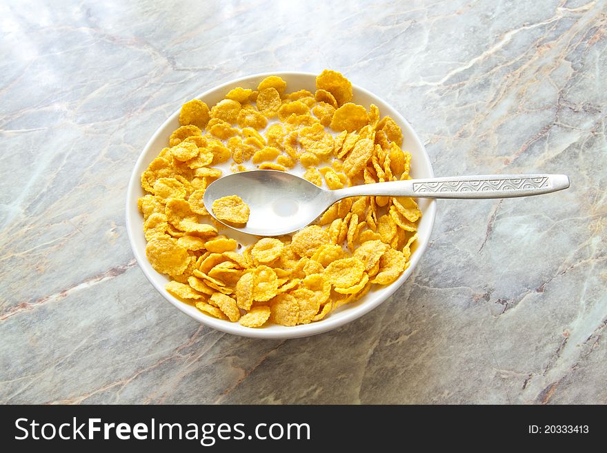 Bowl of cereal with milk on stone background. Bowl of cereal with milk on stone background