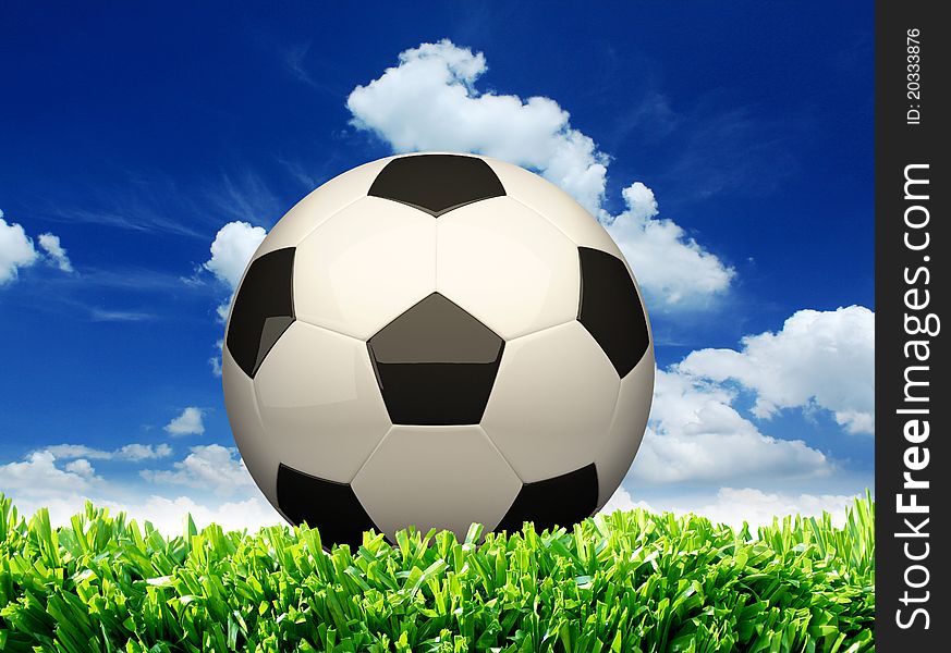 Photo of a football on grass with sky background. Photo of a football on grass with sky background.