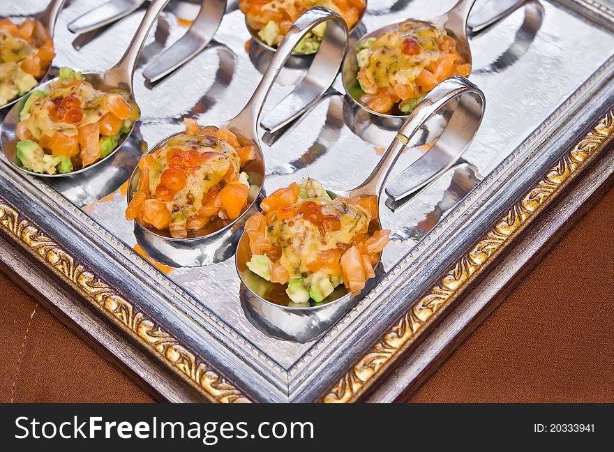 Spoon with delicious salad on frame