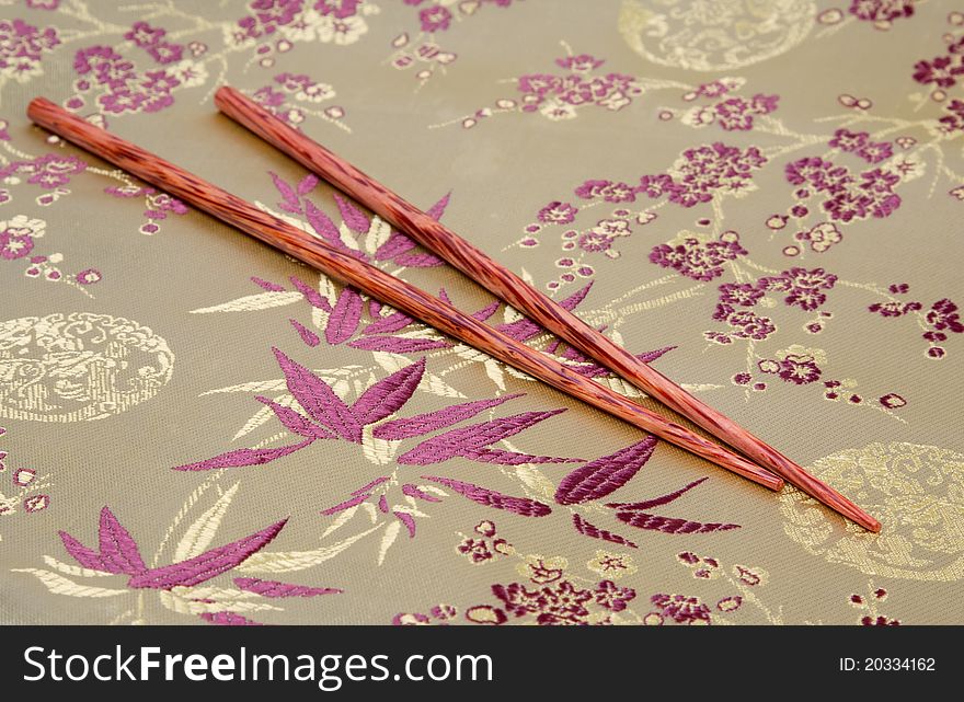 Coconut chopsticks on fabric background
