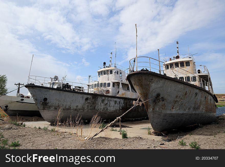 Three old patrol boats in Hulun Lake in China because of years of drought weather.