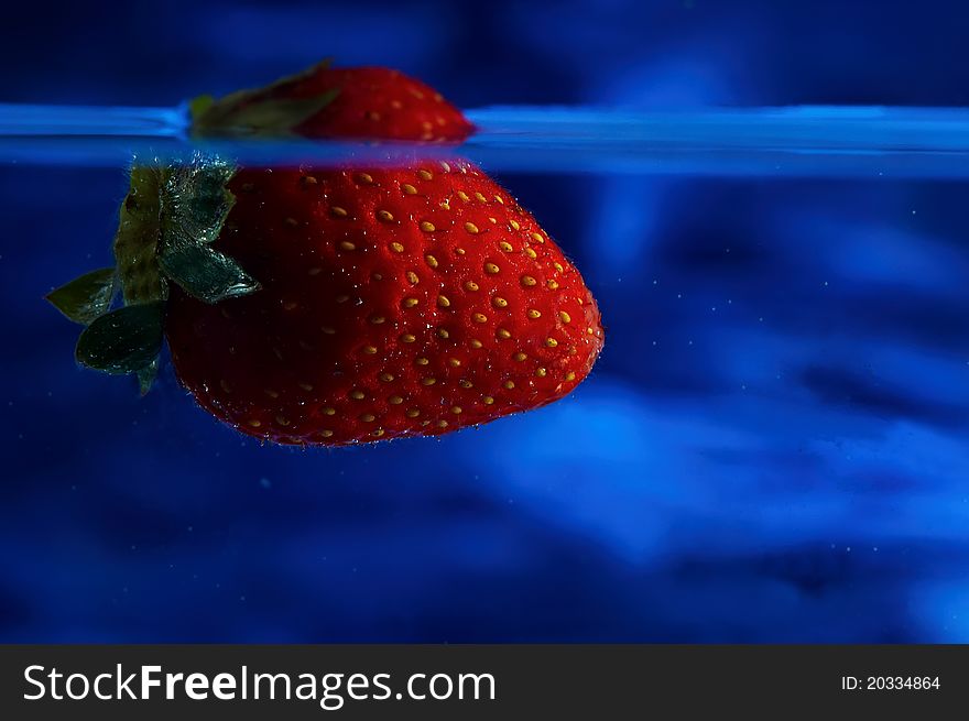 Strawberry submerged in water bath. Strawberry submerged in water bath