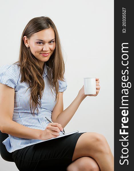 Business Woman Writing notes at desk