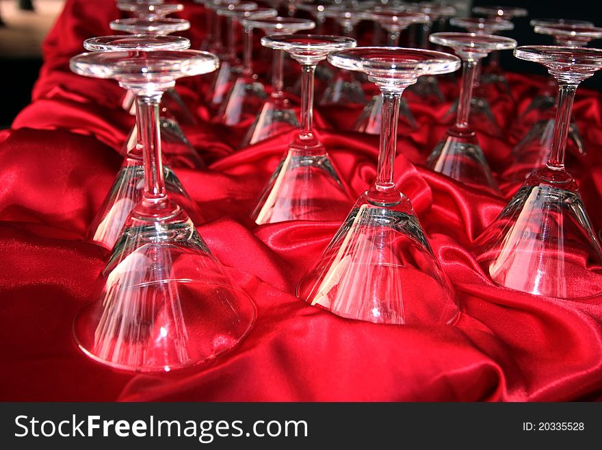 Footed tumblers upside down on the red cloth table restaurant