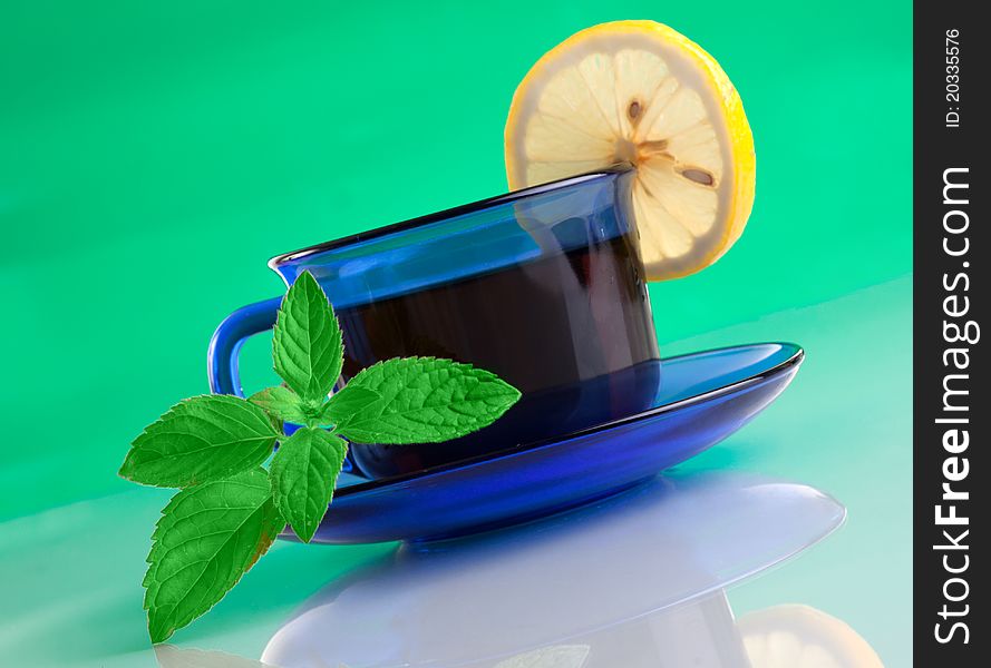 Nice cup of tea and mint (on green background )