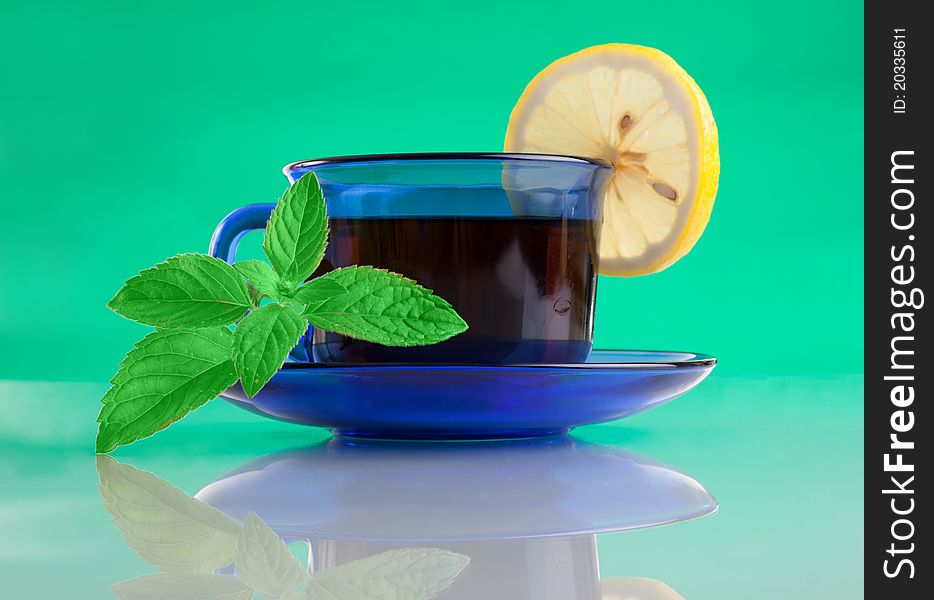 Nice Cup Of Tea And Mint On Green Background