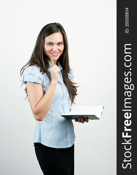 Happy smiling cheerful young business woman with notepad writing, isolated on white background