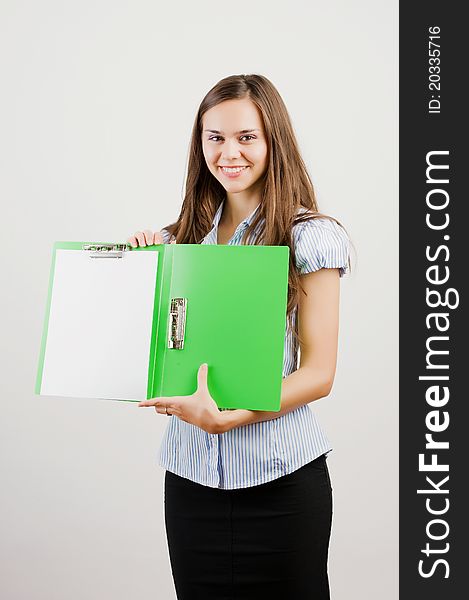 Happy smiling young business woman showing blank area for sign or copyspase, isolated on white background