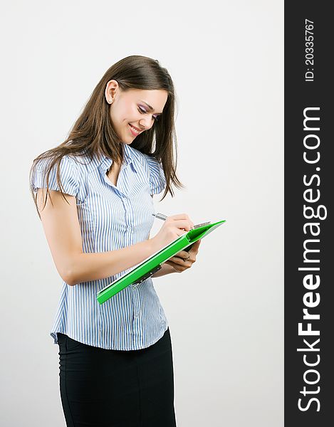 Happy smiling young businesswoman with clipboard writing, isolated on white background