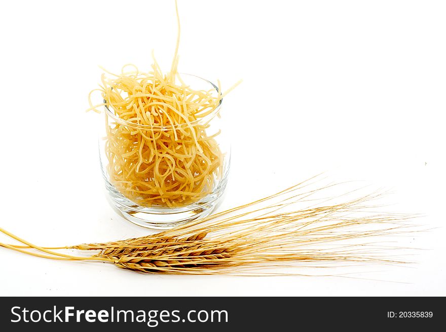 Pasta in a glass of wheat and isolated on a white background