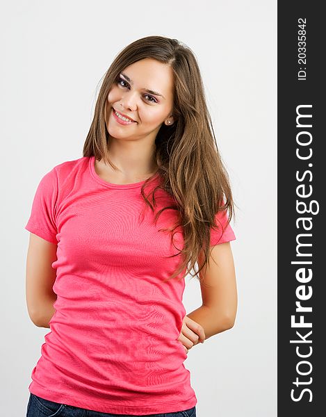 Portrait of a beautiful young woman looking happy against white background