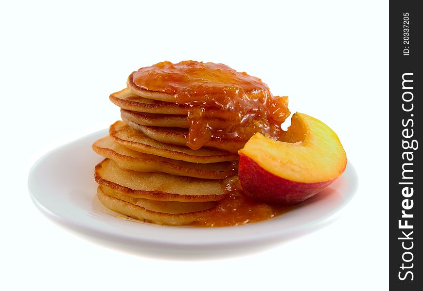 Pancakes with jam on a plate on a white background